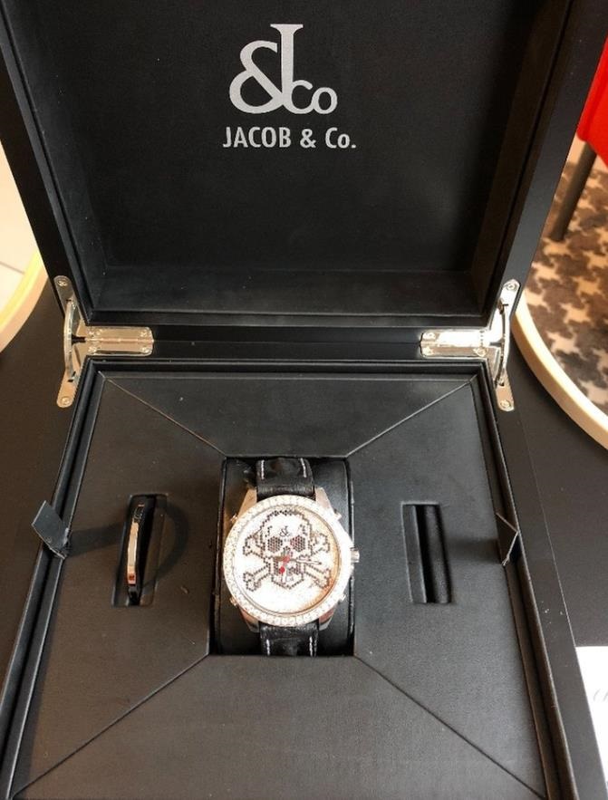 The 47mm replica watch has a diamond-paved dial.